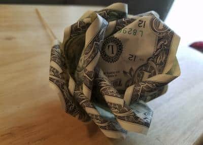 crumpled up dollar bill sitting ona table