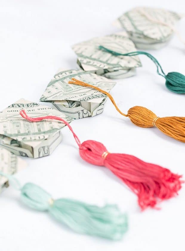 graduation hats made out of money with tassels hanging from them
