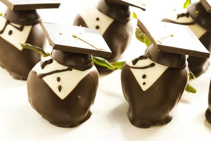 Chocolates that have graduation hats made out of chocolate on them