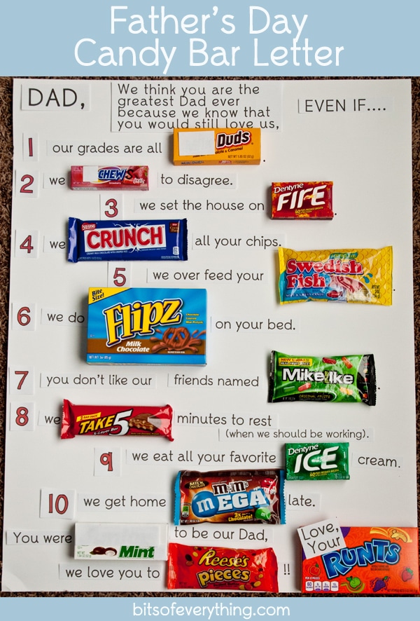 A fathers day candy bar letter with a lot of different types of candy taped to the letter with writing