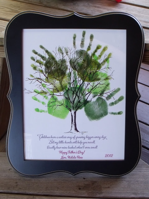 a framed picture of handprints on a tree with writing