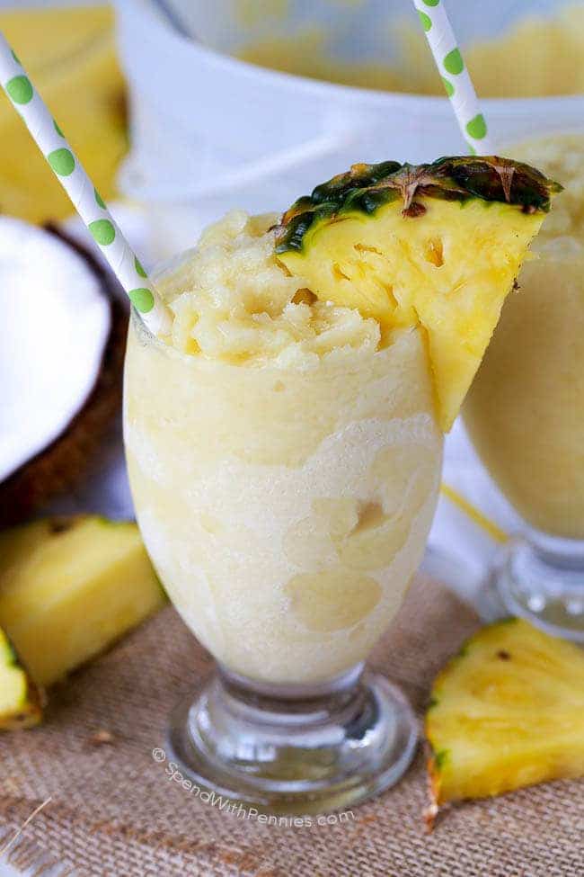 frozen pina colada in a small glass with a straw
