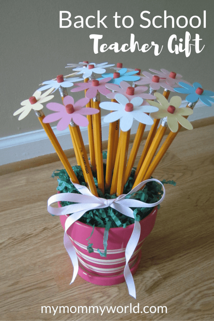 a plant pot that is pink and is filled with pencils that have cut out flower tops around the erasers