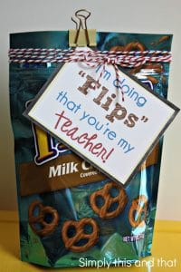 a bag of chocolate pretzels with a tag with writing tied around it