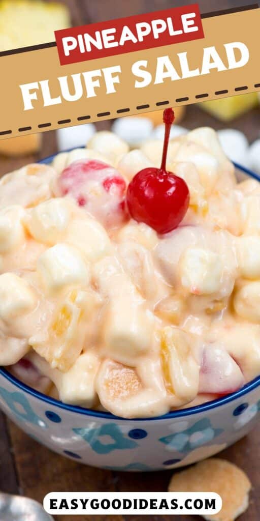 pineapple fluff in blue patterned bowl on wood surface with cherry on top.