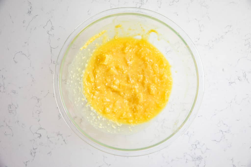 pineapple and pudding mix in clear bowl.