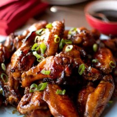Pile of honey baked chicken wings on blue plate
