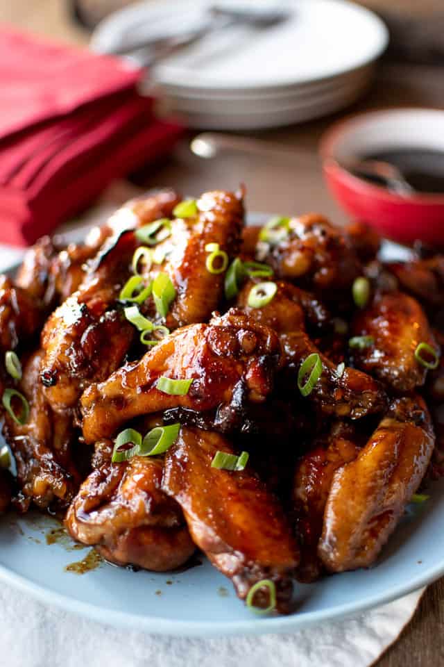Pile of honey baked chicken wings on blue plate