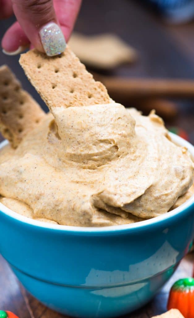 Pumpkin Fluff Dip in a blue bowl with graham crackers
