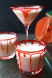 Vampire punch in clear glasses with red dripping down the side