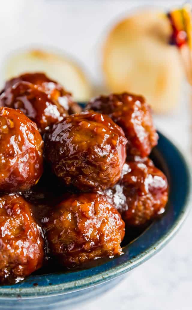 A close up to the side of a bowl of BBQ Meatballs.