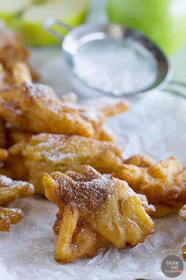 cinnamon apple fritters on parchment paper
