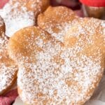 beignets shaped like Mickey Mouse and covered in powdered sugar.