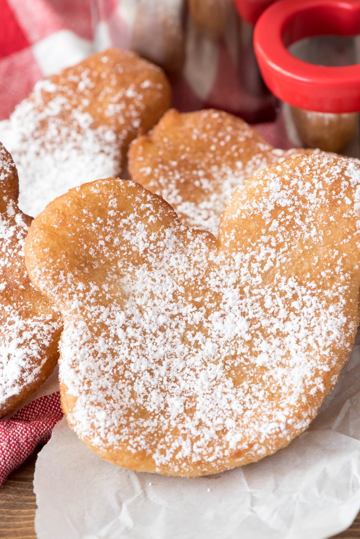 beignets shaped like Mickey Mouse and covered in powdered sugar.