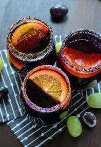 Halloween Sangria shot from above with three colorful drinks in clear glasses