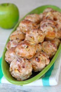baked apple fritters in a green serving dish