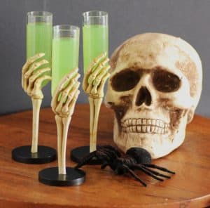 Embalming Fluid cocktail being held by three skeleton hands