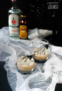 Spiderweb Cocktail with fake spiders on the glasses and a spier web image on top of the drinks