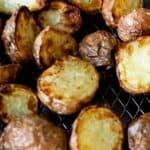 Healthy air fryer potatoes on a wire rack with writing