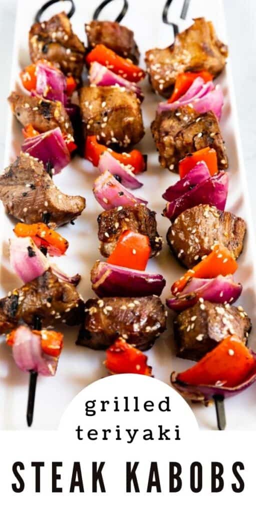 Grill ready steak kabobs on a white platter