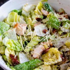 Close up shot of caesar salad in a white bowl