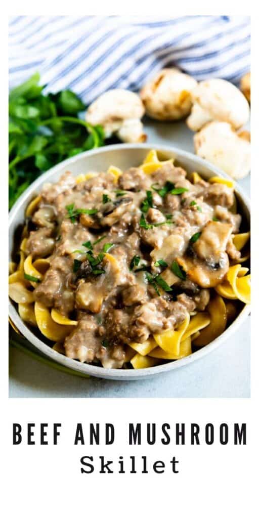 Beef and mushroom skillet in a white bowl served over noodles with recipe title on bottom of image