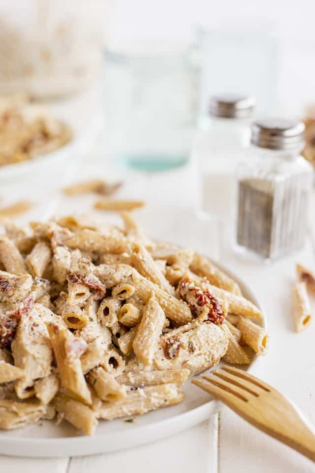 Chicken bacon ranch pasta on a white plate with wood fork