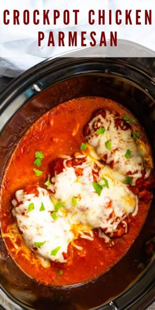 Overhead shot of crockpot chicken parmesan in a black crockpot with recipe title on top of image