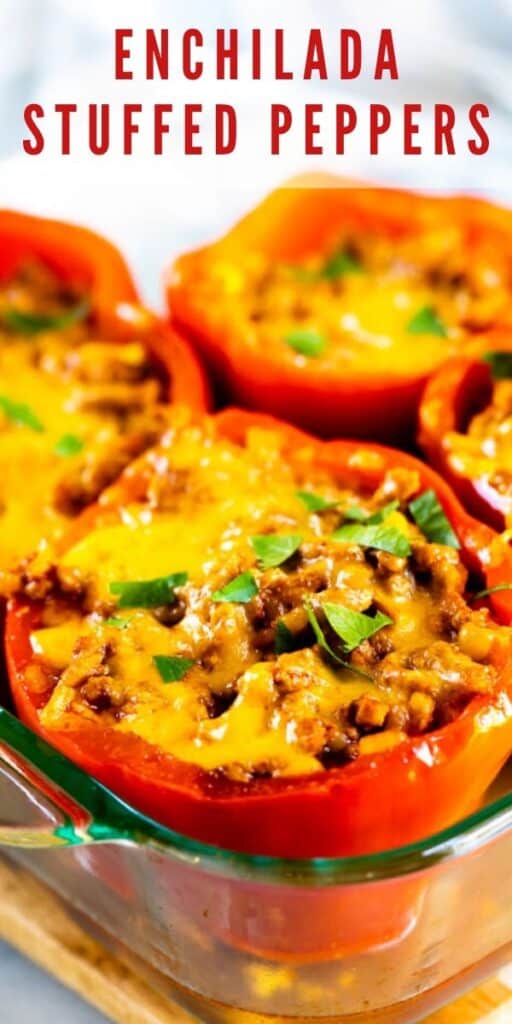 Four enchilada stuffed peppers in glass baking dish with recipe title on top