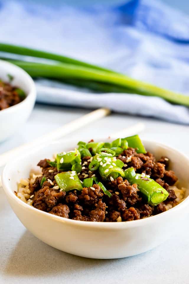Korean beef bowl on counter with green onions in background