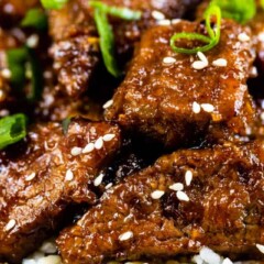 Mongolian beef with green onions on top of white rice