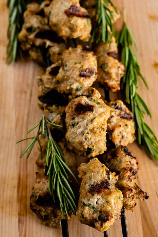 Turkey kabobs with rosemary on a wood cutting board