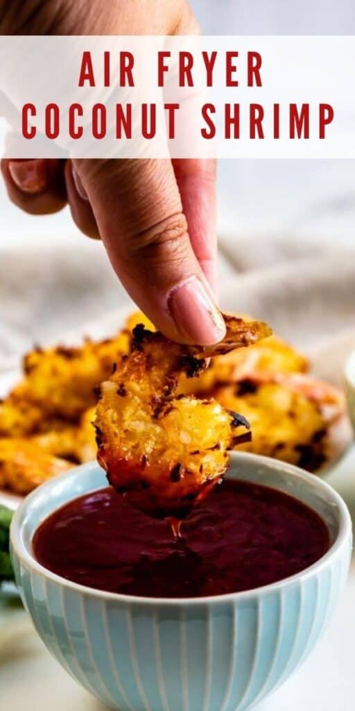 Coconut shrimp being dunked into dipping sauce with recipe title on top of image