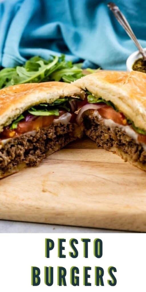 Pesto burger cut in half on a wood cutting board with recipe title on bottom of image