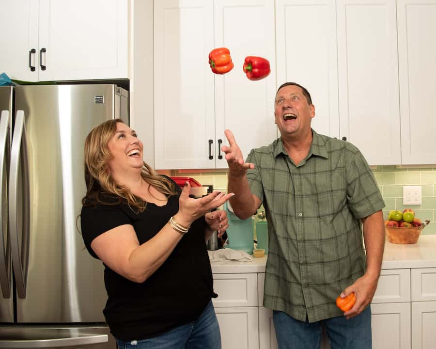 man and woman juggling bell peppers