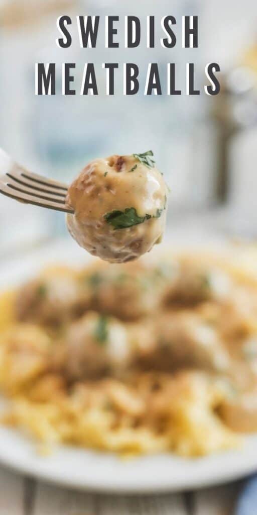 Close up shot of one swedish meatball on a fork in focus with rest of plated dinner behind out of focus with recipe title on top of image
