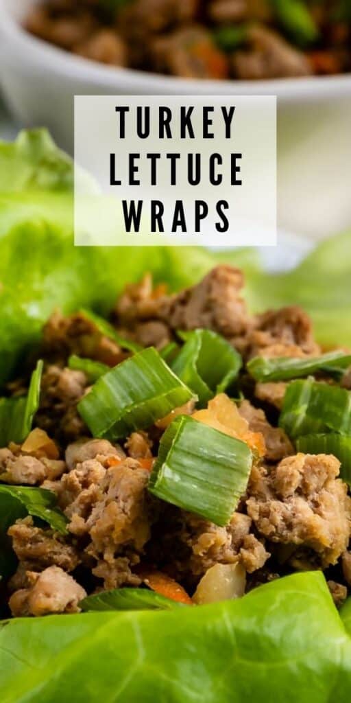 Close up of lettuce leaf filled with ground turkey and topped with green onions and recipe title on top of image