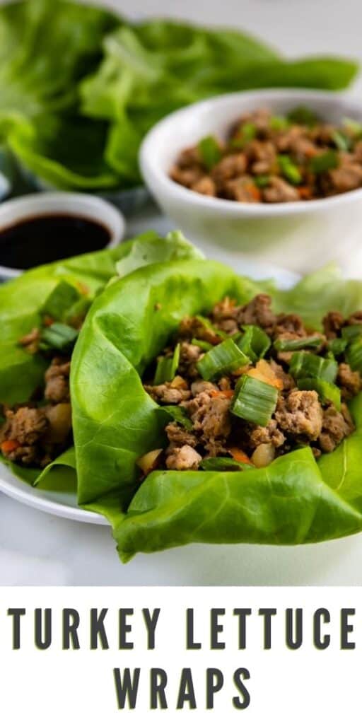 Close up shot of turkey lettuce wraps on a plate with extra ground turkey and sauce in background and recipe title on bottom of photo