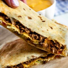 Close up photo of crunchwrap supreme cut in half to show filling