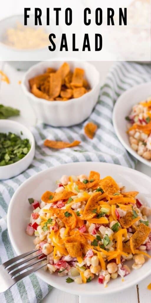 Frito corn salad in bowls on table with ingredients in background and recipe title on top of image