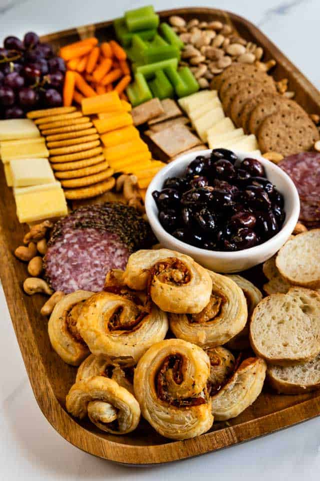 Side view of a finished charcuterie board with lots of snack options