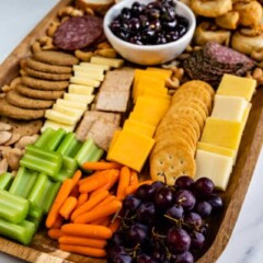 Side view of a finished charcuterie board with lots of snack options