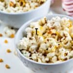 Two bowls of kettle corn with recipe title on bottom of image