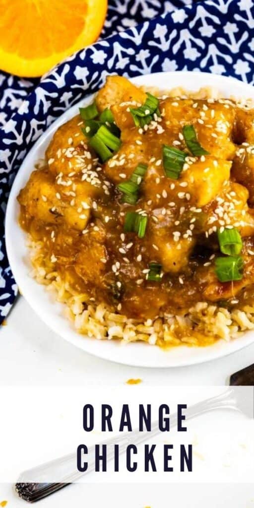 Overhead shot of orange chicken over rice in a white bowl with fork next to it and recipe title on bottom of image