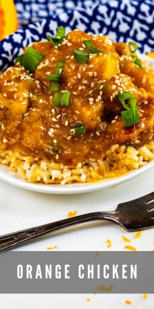 Plate of orange chicken over rice with a fork next to it and recipe title on bottom of image