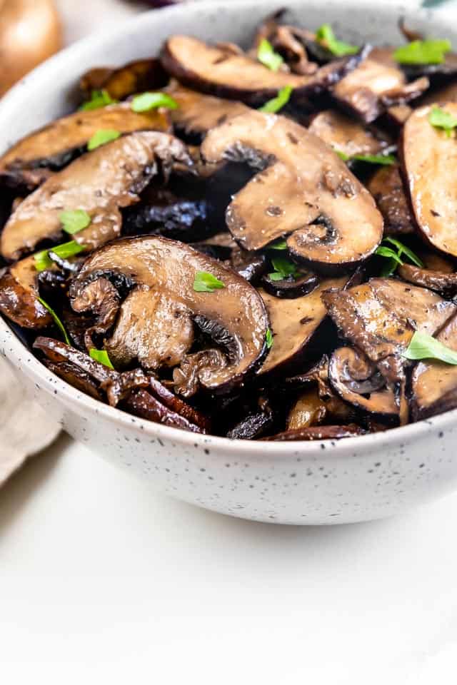 Close up photo of oven seared mushrooms in serving bowl