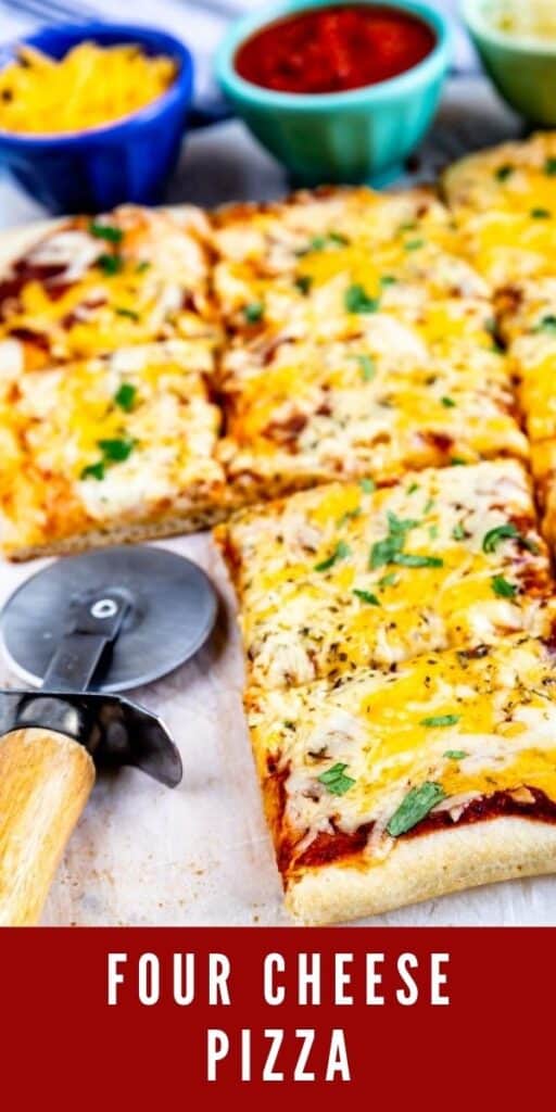 Four cheese pizza cut into squares with pizza cutter and cheese in background and recipe title on bottom of photo
