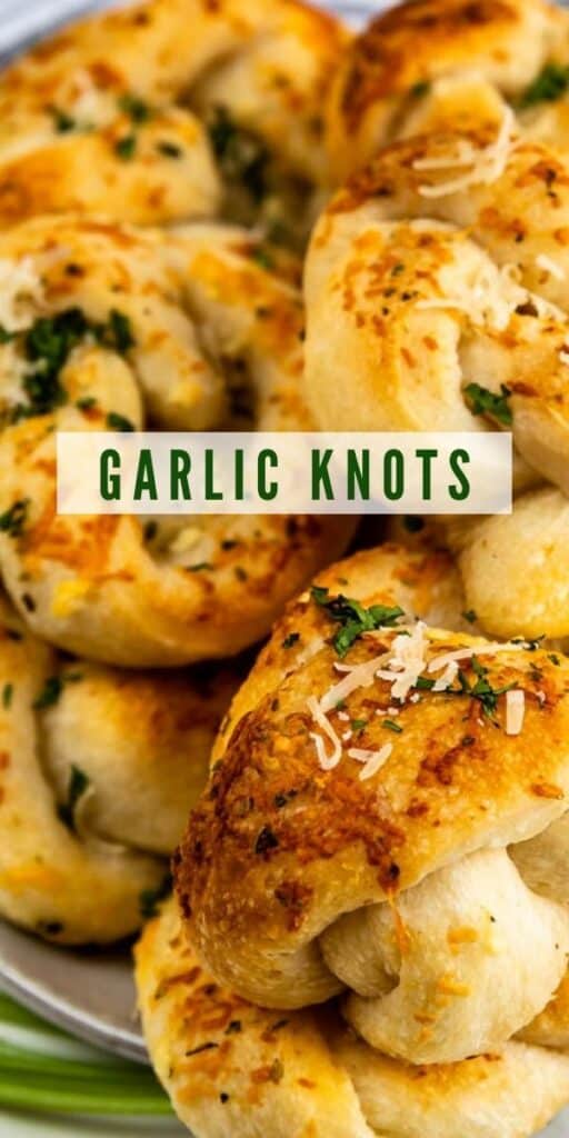 Close up photo of garlic knots on a plate with recipe title in middle of photo