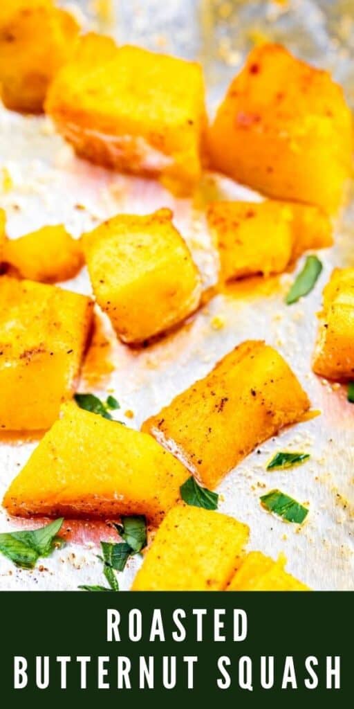 Close up shot of cubed butternut squash on a sheet pan covered in foil with recipe title on bottom of photo