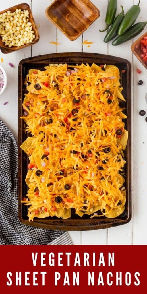 Overhead view of sheet pan nachos with all the toppings on top and recipe title on bottom of photo